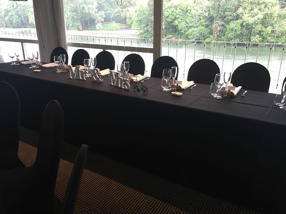Bridal table dressed in black with river view at The Ferrybank