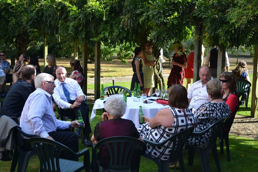 Henley Hotel - Guests seated in gardens enjoying drinks and canapes