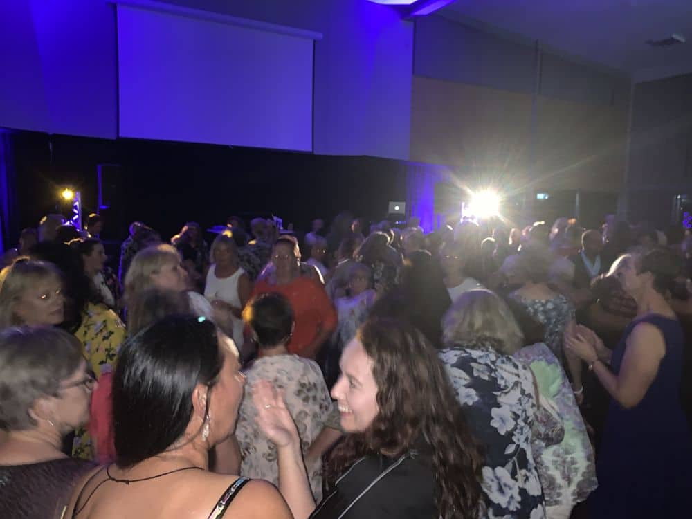 Sir Don Rowlands Centre - Corporate guests dancing in the main hall with a DJ