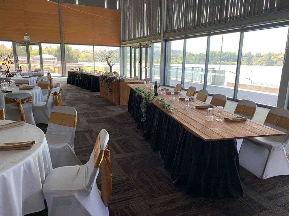 Sir Don Rowlands Centre - Rustic Bridal table set in front of windows in Main Hall