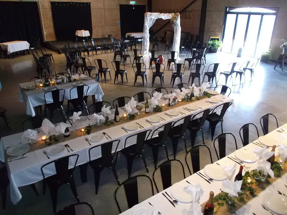 The Grain Exchange - Wedding Tables and Chairs set for indoor ceremony