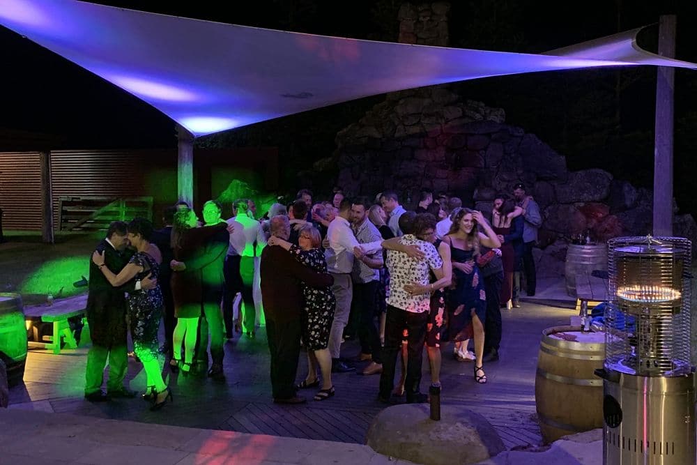 The Red Barn - Guests dancing by the out door fire place