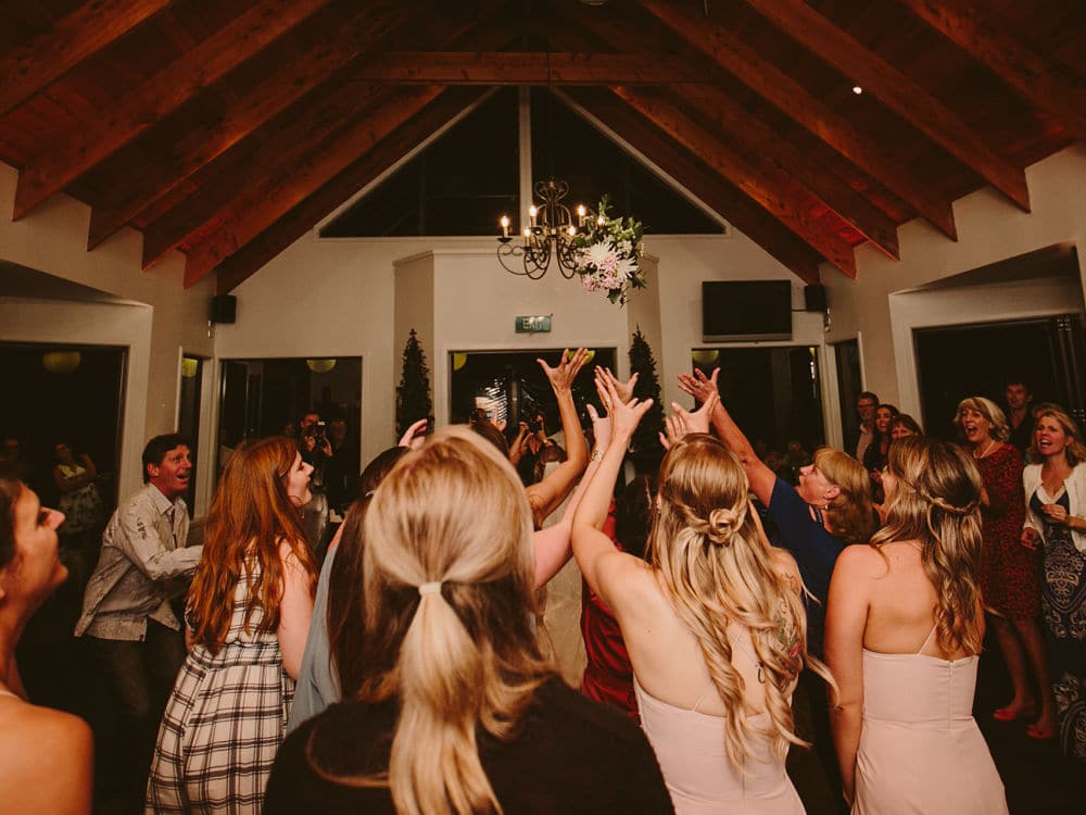 Woodside Estate - Female wedding guests attempting to catch the bouquet