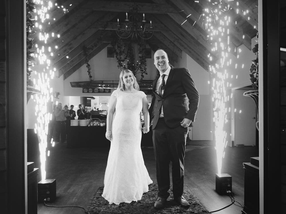 Woodside Estate - Bride and Groom pose for a photo between indoor fireworks