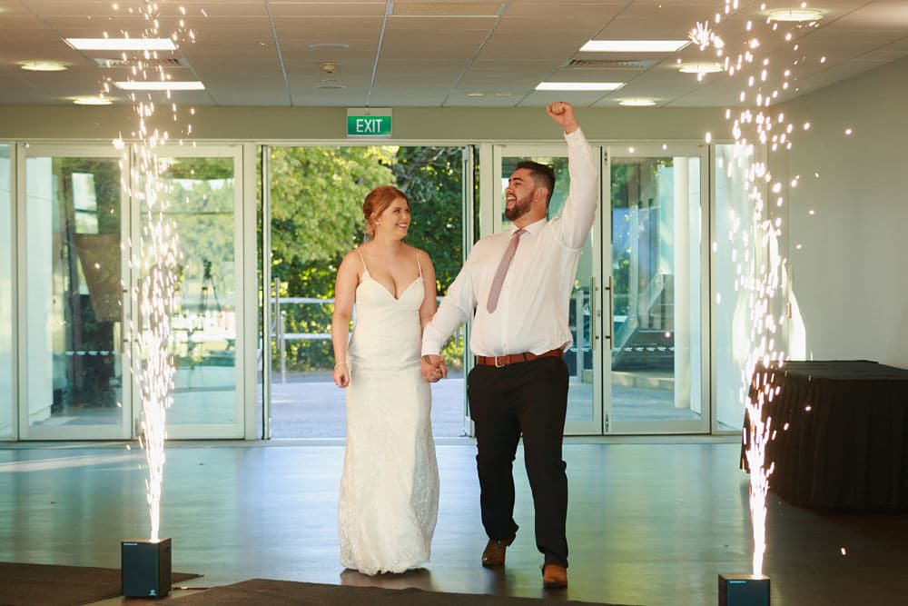 Awapuni Racing Function Centre - Bride and Groom walking into reception with indoor fireworks (sparkulars)