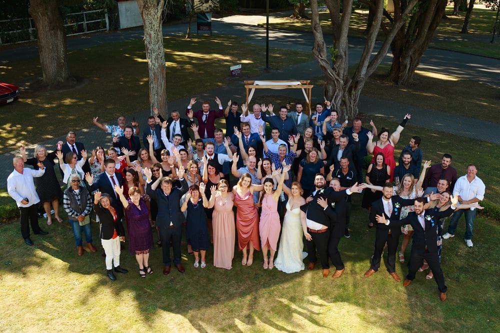 Awapuni Racing Function Centre - Family Photo with Bride and Groom Outside lower Floor function room