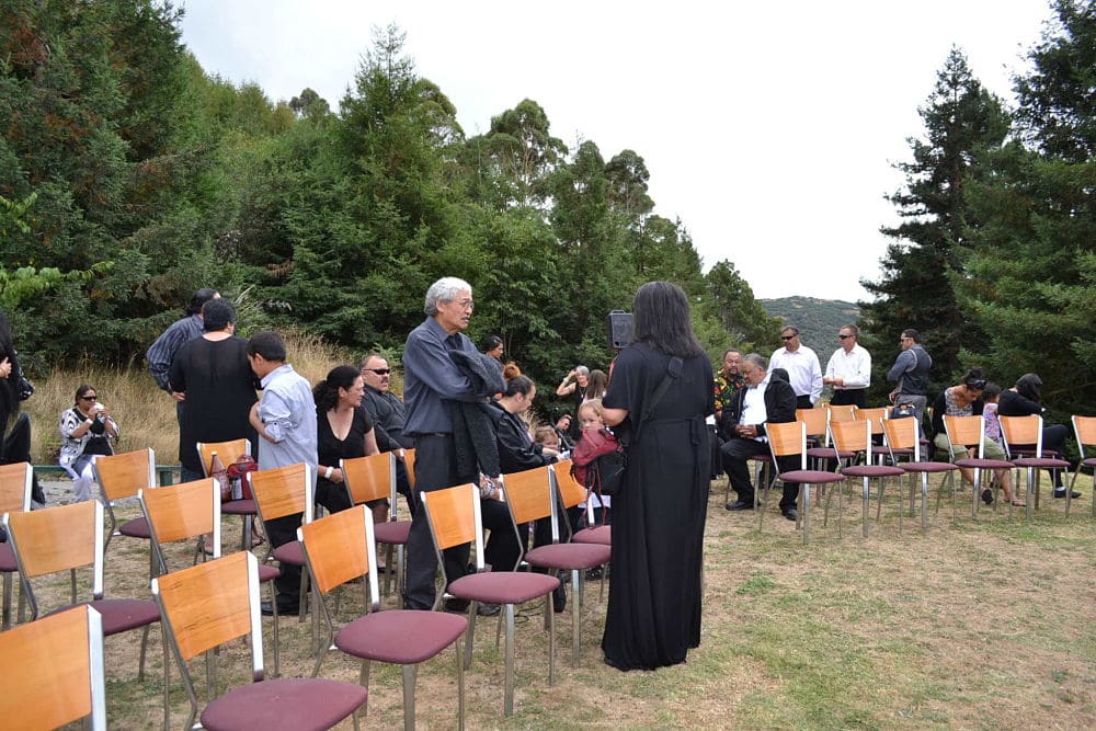 Skyline Rotorua Hidden Forest Venue - Guests mingling at top of hill waiting for wedding ceremony to begin