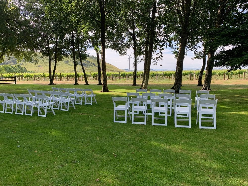 Te Awa Winery - Wedding ceremony guests chairs set up outside under trees