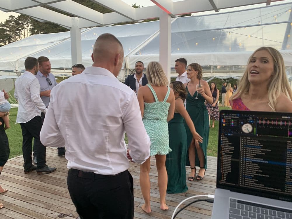 Orua Beach House - Wedding guests dancing before night fall