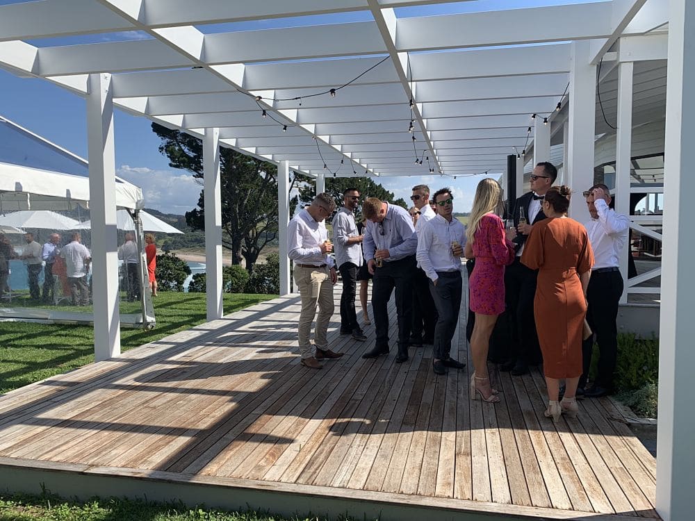 Orua Beach House - Wedding guests enjoying a little shade on a hit summer day
